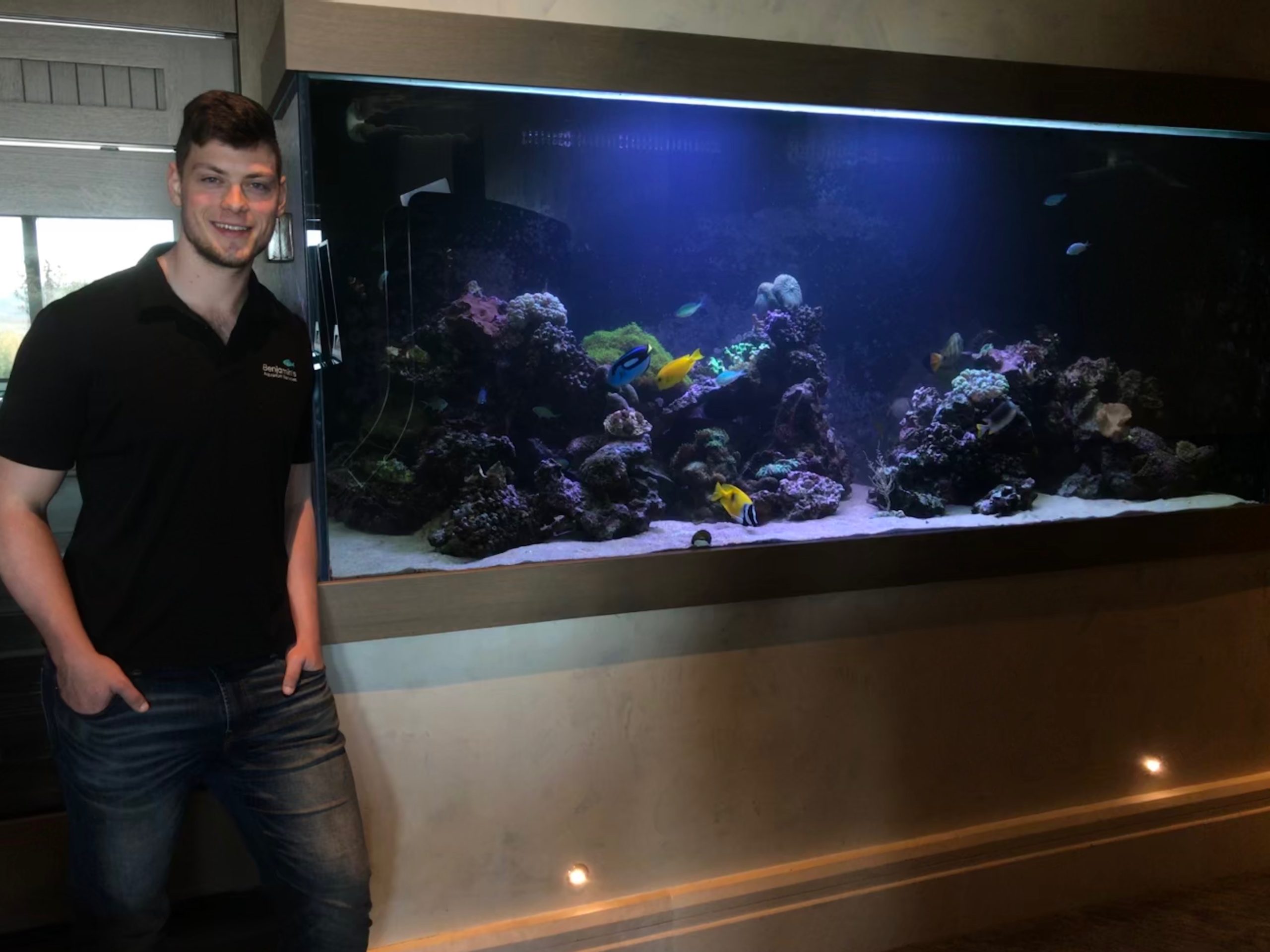 Owner In Front Of Maintained Aquarium Owner In Front Of Cleaned Fish Tank